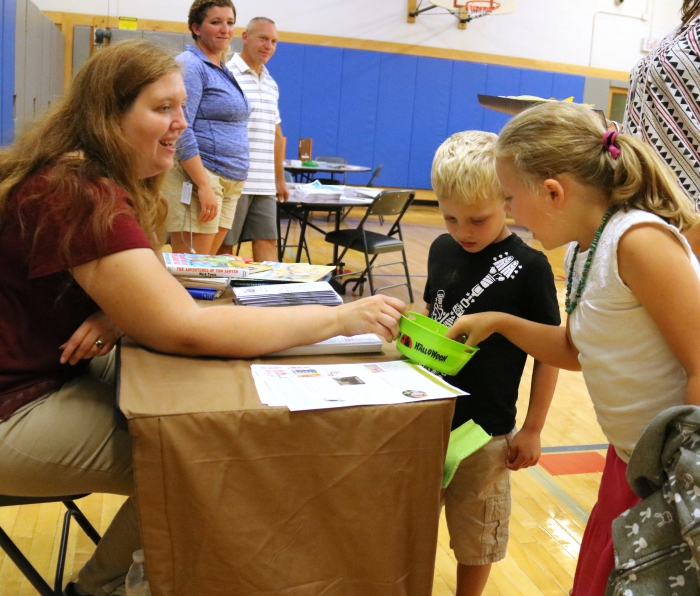 Danielle and Finn Connors check out the public library table manned by Mrs. Robbins during the recent Open House at Sandy Creek Elementary School