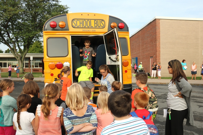 Students practice bus evacuations using the rear emergency exit during a recent drill at Sandy Creek Elementary School.