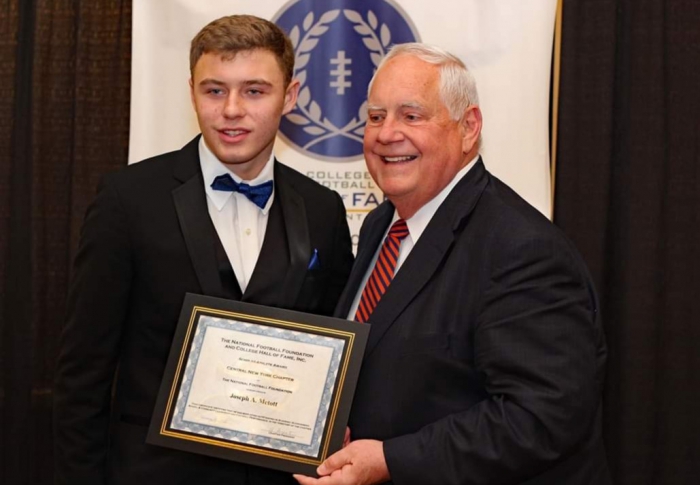 Joe Metott receives a CNY Chapter Scholarship from John Cherundolo at the NFF Scholar-Athlete Dinner held recently.