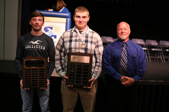 Wrestling award recipients Marshall Coe (Larry Miller Memorial Wrestling Award); and Caleb Miller (Nate Woolson Memorial Award); are pictured with Mike Stevens, Athletic Coordinator following the awards ceremony. Other Wrestling awards included the Terry Miller Wrestling Award to Levi Darling and Art Jones to Joe Benedict.