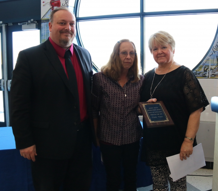 Linda Taber, far right, was named to the Wall of Excellence in the Sandy Creek Central School District, honoring her commitment to students, staff and community. Pictured at left is Sandy Creek Superintendent of School Kyle Faulkner, and Roxanne Paro, who nominated Taber for the honor.