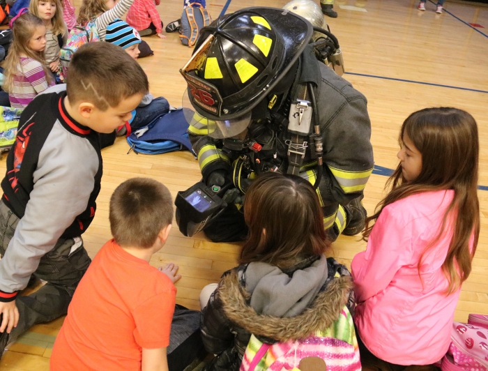 Sandy Creek Volunteer firefighter, Kristyn Fontana shows students at Sandy Creek Elementary how firefighters use a thermal imaging camera to find someone trapped in a fire when their visibility is impaired by smoke in a building.
