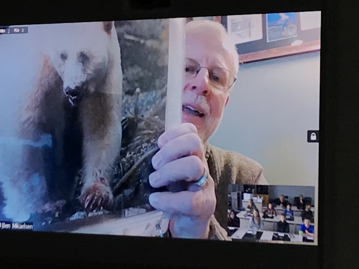 Author Ben Mikaelsen holds a picture of the spirit bear he was lucky enough to see and photograph while traveling in British Columbia.
