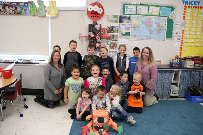 Students in Heather Wallace’s first grade class at Sandy Creek Elementary School pose with their monster (below) and the monster created from the instructions provided by their partner class in Copiague (at top).