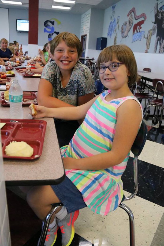 Friends were eager to reconnect during the lunch period at the Middle School where 6th graders Elizabeth Hobbs, left and Kelsie Ridgeway, right, enjoyed their lunches.