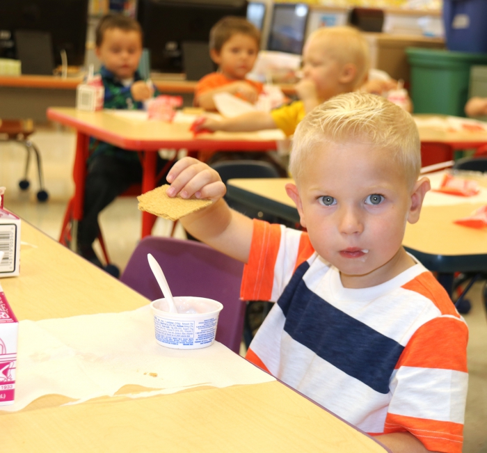 Pre-kindergartner Bradley Brown enjoys snack time on the first day of school.