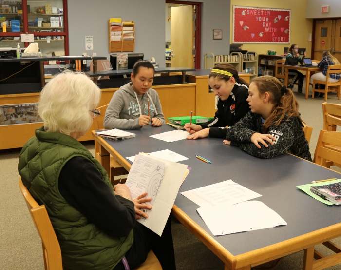 Karin Nemier, left, coaches Sandy Creek Middle School students Abby Chen, Maiya Hathway and Elizabeth Glazier in preparation for the District Level Battle of the Books Competition to be held on February 7th at 6:00 p.m. in the middle school/high school auditorium.