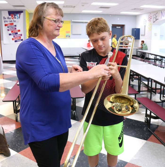 Mason Ennist with band teacher Valerie Marshall at Sandy Creek Elementary School Instrument Night.