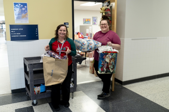 SCCS Social Worker Buffy Peterson and volunteer Kayla Filiatrault pass out gifts to Sandy Creek families before the holidays. 