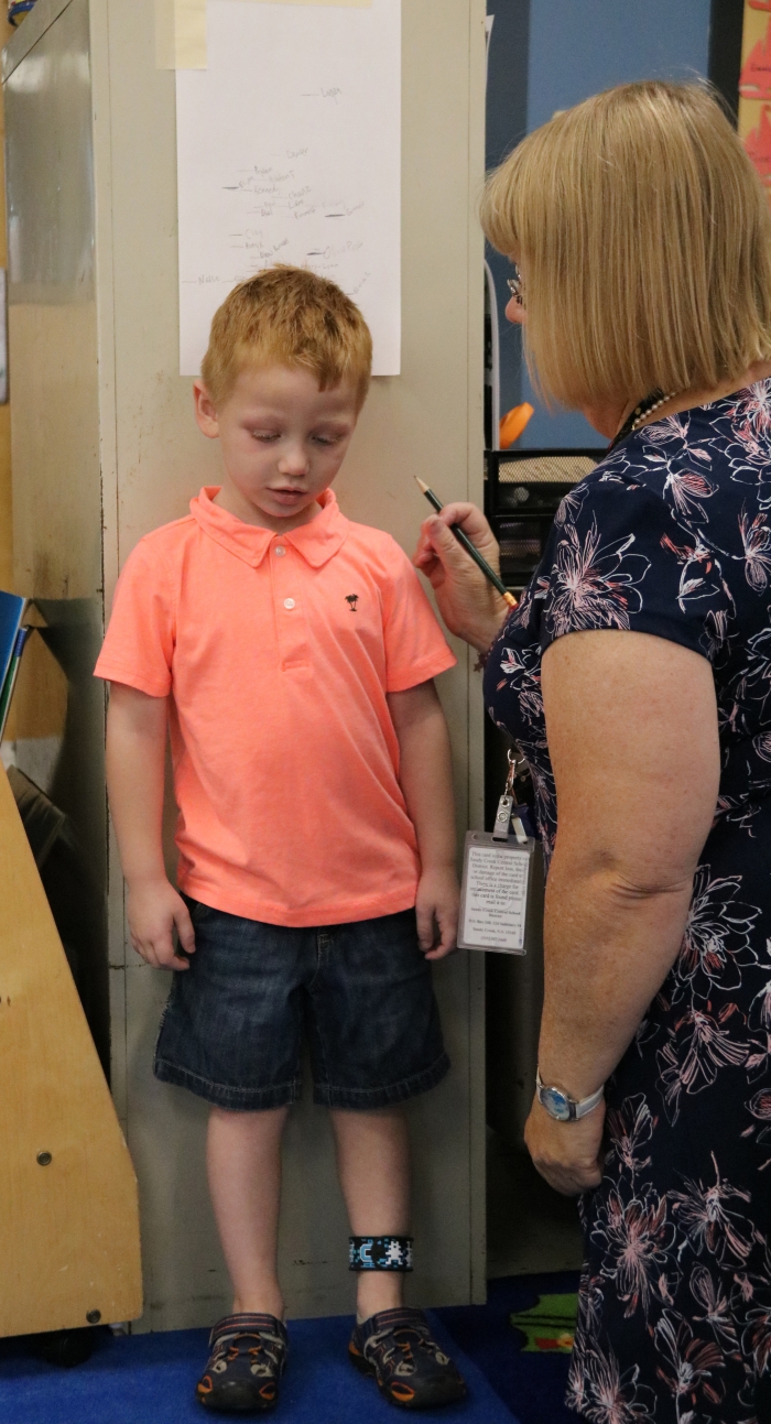 While his mom completed paperwork, Ashton Town was measured. 
