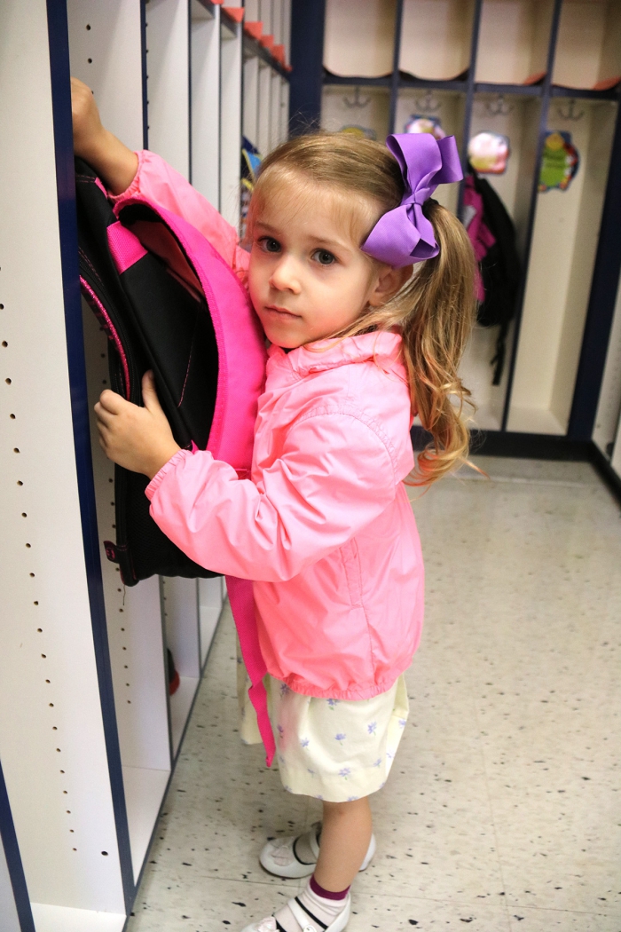 Amelia Crast puts her backpack away on the first day of pre-kindergarten in the Sandy Creek Central School District.