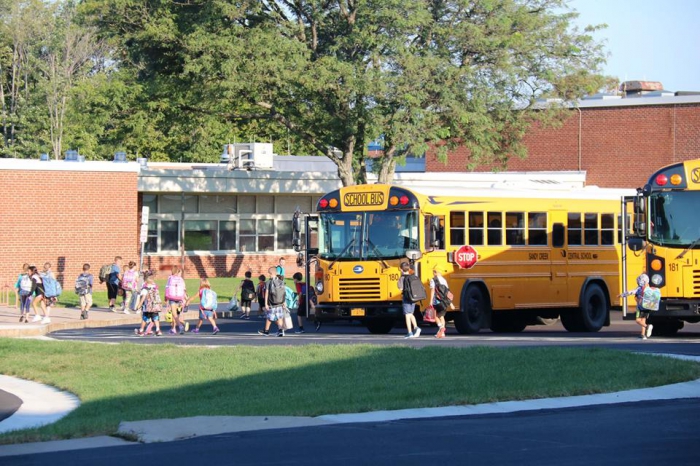 Vehicle traffic was contained to the elementary parking lot for student drop off on opening day of school. Students were able to exit their buses safely without worry of nearby cars dropping off students at the side entrance to the school. A grass median was installed to further divide the two spaces and staff were on hand to direct vehicles into the parking lot for drop off.