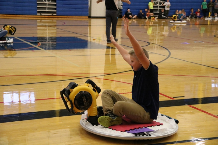 Brayden Metott celebrates successfully meeting the required distance to remain in the competition during the Hovercraft Project at Sandy Creek Middle School.
