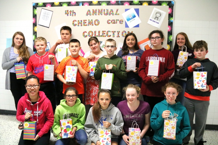 Sandy Creek Middle School Student Council members hold some of the chemo care packages they created to donate to a local treatment center.