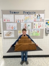 A student proudly displays his handmade project.
