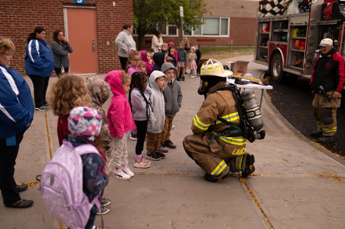 A volunteer fire fighter from Lacona teaches Sandy Creek students about fire safety and prevention. 