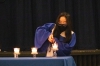 A Sandy Creek student lights one of the candles, signifying the beginning of the induction ceremony.
