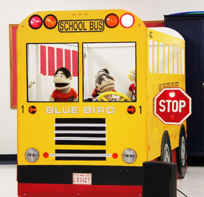 Puppets operated by the SCCS Transportation staff sing songs regarding bus safety practices like staying in your seat and not being a bully.