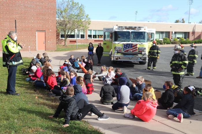 Sandy Creek Volunteer Fire Department Captain Lyle Robbins talks to Sandy Creek Elementary students during a recent presentation on fire safety outside.