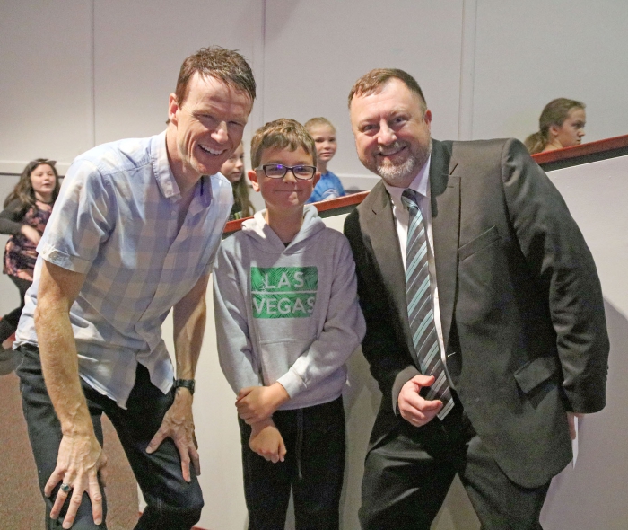 Andy Thibodeau posed with Brody Pecha, center, and Elementary Principal Tim Filiatrault, right following his presentation to the elementary students.