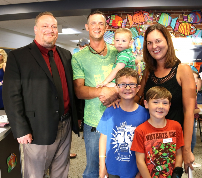 Sandy Creek Superintendent Kyle Faulkner greets the Pecha family at recent Open House.