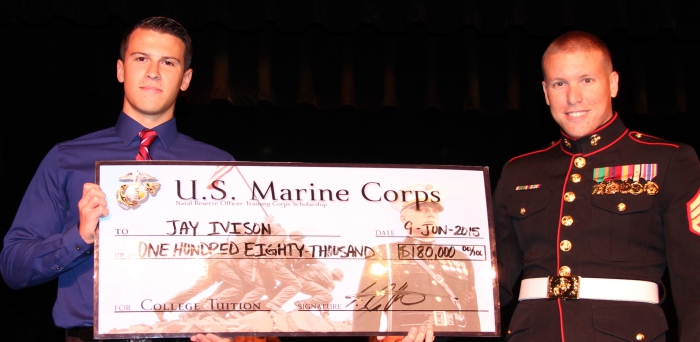 Jay Ivison, a senior in the Sandy Creek Central School District, receives the prestigious Reserve Officers Training Corps scholarship from Marine Staff Sgt. Holt. The $180,000 check will cover the cost of tuition as Ivison pursues a degree at George Washington University in Washington, D.C.