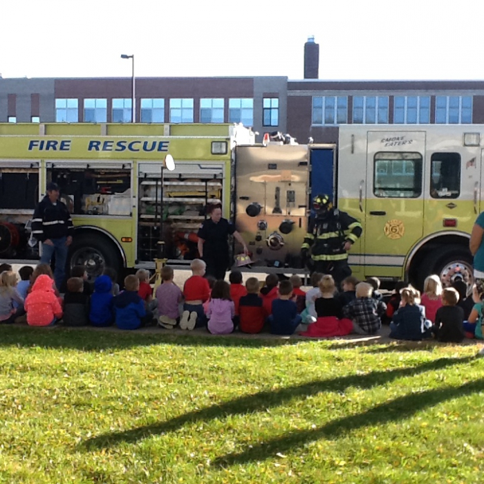 Kindergarten students listen intently as the fire department volunteers talked to them about fire safety. 