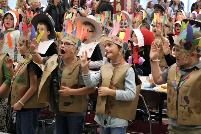 Pilgrims and Native Americans joined together for the first and second grade annual Thanksgiving Feast. The students performed several songs for the audience gathered at the school.