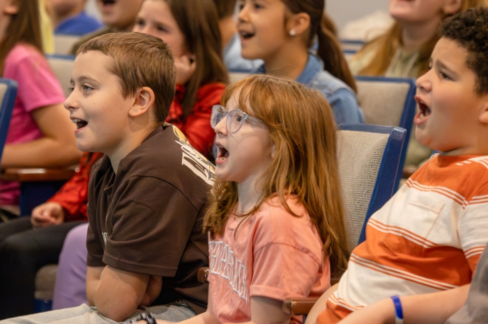 Students sing to Jared Campbell's performance.